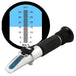 Brix refractometer with a magnified scale showing Brix percentage.