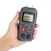 Hand holding a digital wood moisture meter with a white background