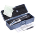 Handheld refractometer in a blue case with a cleaning cloth and operation manual on a white background