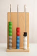 Colorful abacus-like tool with wooden base on a plain background
