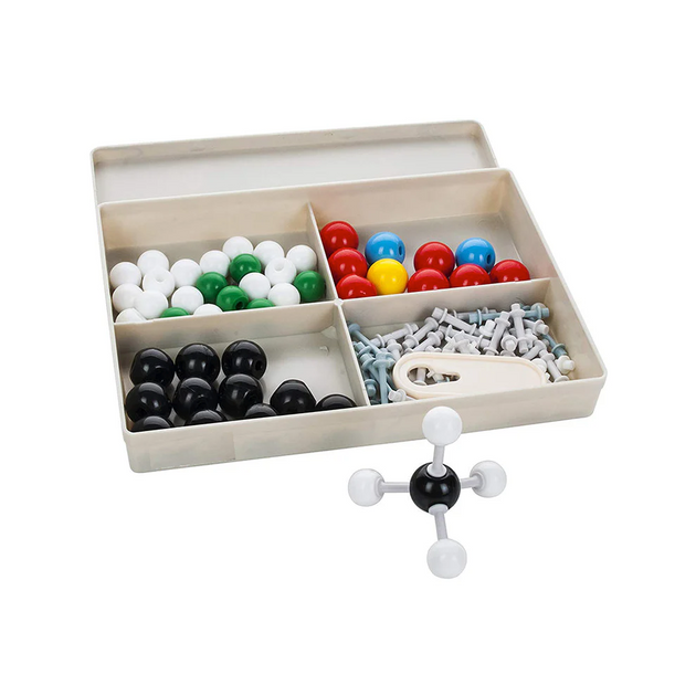 Set of molecular model kits with colorful balls and a white molecular model on a beige tray.